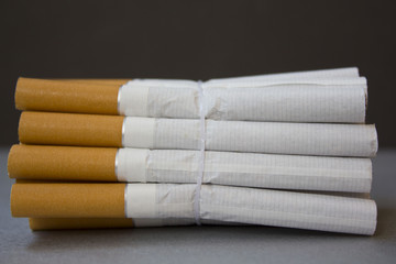 the group of cigarettes wrapped over a gray background