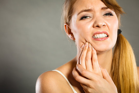 Woman suffering from tooth pain