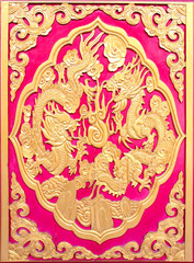 Wood carved on red door in Chinese Temple