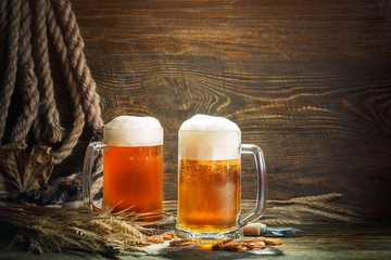 Glasses of fresh beer on a wooden table.