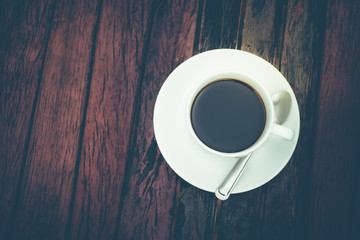 A white coffee cup on wooden table in the garden, Black coffee on wooden background, coffee break in the morning, relaxing and refreshing concepts.