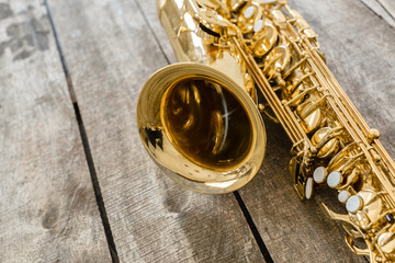 Beautiful golden saxophone on wooden background