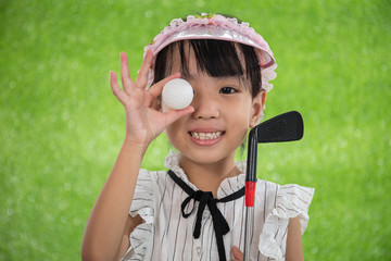 Asian Chinese little girl holding a golf ball