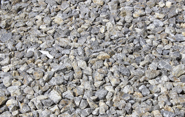 Rough uneven gray stone background old curve sprinkled gravel