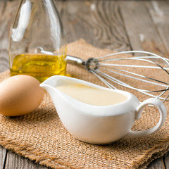 Fototapeta na wymiar Fresh homemade Mayonnaise with egg and oil in bottle