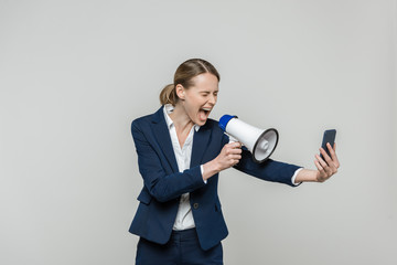 businesswoman with smartphone and loudspeaker