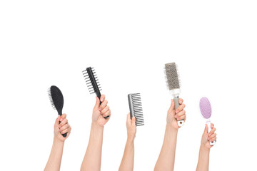 hands holding hairbrushes
