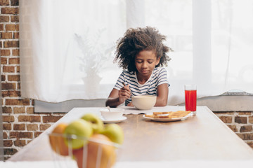 Little girl eating breakfast