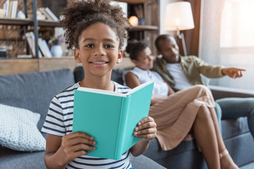 Little girl with book in hands