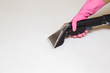 Mattress or bed chemical cleaning with professionally extraction method. Hand in rubber protective...