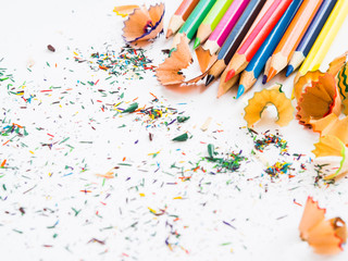Soft focus colorful pencils with colorful pencil shavings on white background. Back to school...