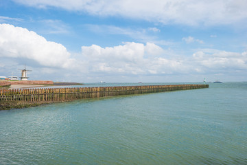 Dike protecting land against the sea in sunlight