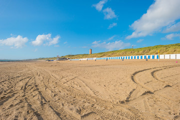Sand dunes along a beach in sunlight in summer