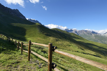 Fototapeta na wymiar Mountain wooden fence. Mountain rural road