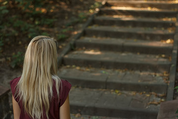 woman going up the stairs in the park