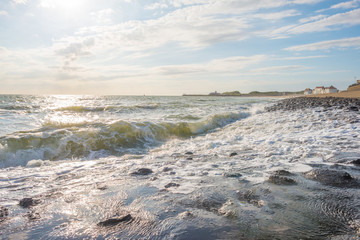 Dike protecting land against the sea in sunlight