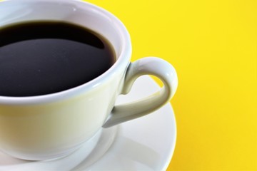 An Image of a Cup of coffee - yellow background