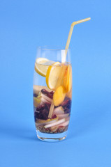 Glass with drink detox dry grapes, pear, lemon on blue background