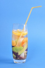 Glass with drink detox dry grapes, pear, lemon on blue background
