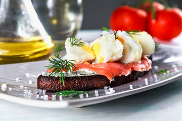 sandwich with ricotta cheese, salmon and poached egg on a plate