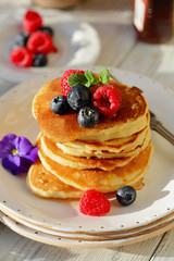 Golden pancakes with summer berry and honey