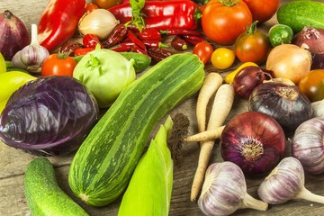 Vegetables on a wooden board. Sales of vegetables on farm markets. Place for your text.