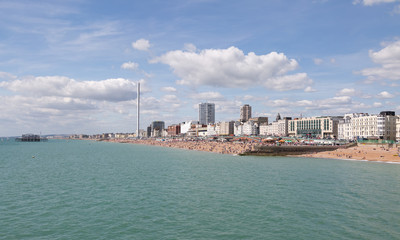 Fototapeta premium Brighton seafront and town with people enjoying the sunny beach