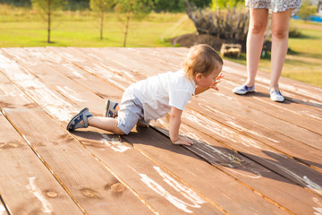 Smiling happy baby boy on natural background in summer or autumn