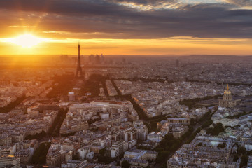 Spectacular sunset in Paris, France. Aerial panoramic view from the Tour Montparnasse with the Eiffel Tower and the Invalides. Beautiful skyline. Travel background.