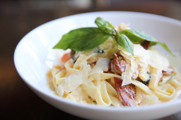 Chorizo sausage spaghetti fettuccine on wood background