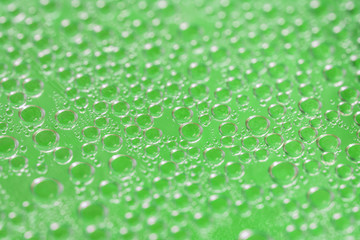Condensate. Green water drops background. Selective focus, close-up