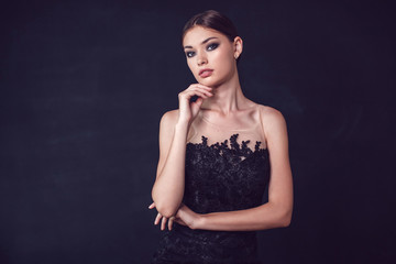 Fototapeta premium Attractive woman with make up on a dark background.