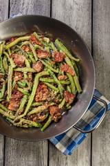 Healthy sauteed green beans with bacon, onion, and bread crumbs