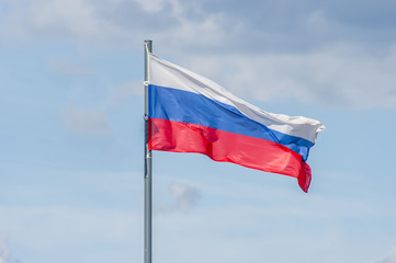 The National flag of Russia flay over the blue sky
