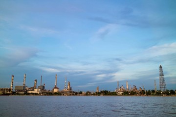 Oil refinery plant near river at twilight, Business and  Industry concept