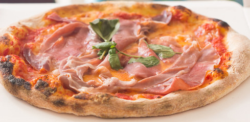 Hot true ITALIAN PIZZA pepperoni pizza on board on white wooden table with decoration. Copy space for your logo. Ideal for commercial.