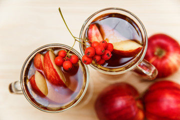 Beverage with autumn fruits.Apple,rowan berry.Wood background.Fall concept.top view