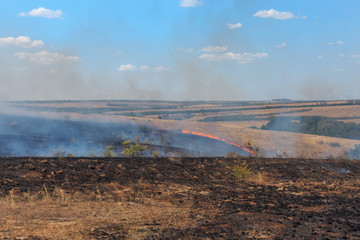 Rostov region fields in wildfire or natural fire, fields and hills with dry grass are burned
