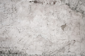 Grunge textured background, old cracked plaster on the wall of the house