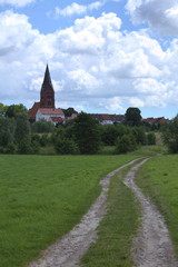 Fototapeta na wymiar View over meadow to the town of Guetzkow, Mecklenburg-Vorpommern, Germany