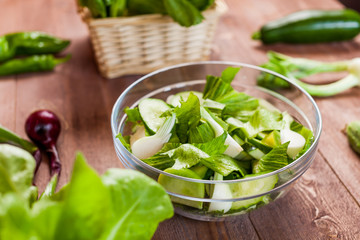 vegetable green salad bowl on kitchen table, balanced diet