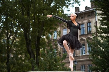 Stunning expressive ballet performance of a professional female dancer wearing black swan outfit...