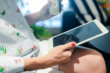 Business person using holding digital tablet mobile pc device over blurred background. Close up technology concept