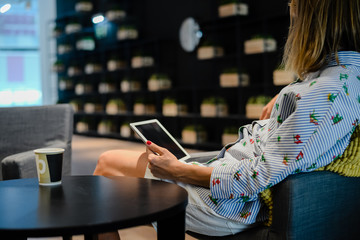 Business person using holding digital tablet mobile pc device over blurred background. Close up technology concept