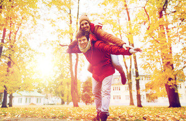 happy young couple having fun in autumn park