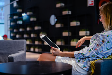 Business person using holding digital tablet mobile pc device over blurred background. Close up technology concept