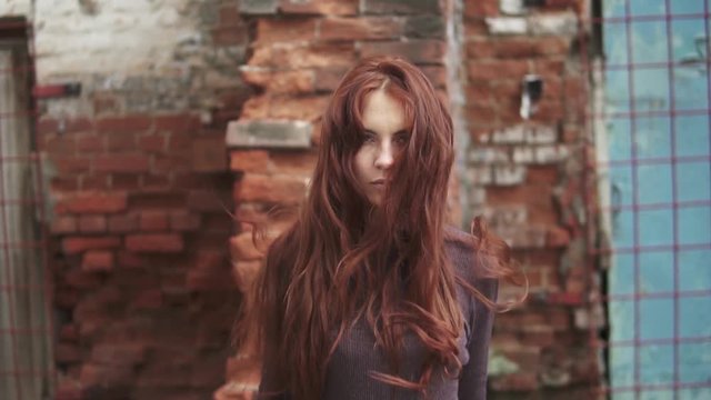 portrait of a young red-haired witch, her hair rising up And stands on end