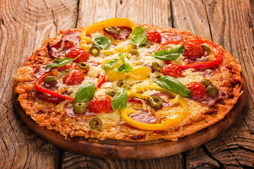 Delicious pizza served on wooden plate 
