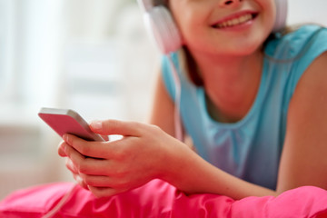 girl in headphones listening to music at home