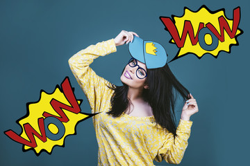 Model woman young and beautiful in the style of pop art on a blue background painted in a cap with a crown